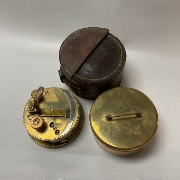 Vintage brass pocket sextant in leather case, nautical instrument.