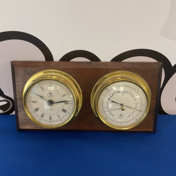 Vintage GB barometer clock with integrated time display.