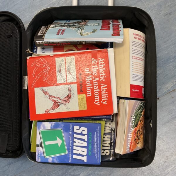 Porsche case containing a collection of vintage books.