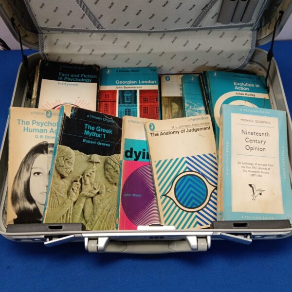 A collection of vintage Pelican books with colourful covers.