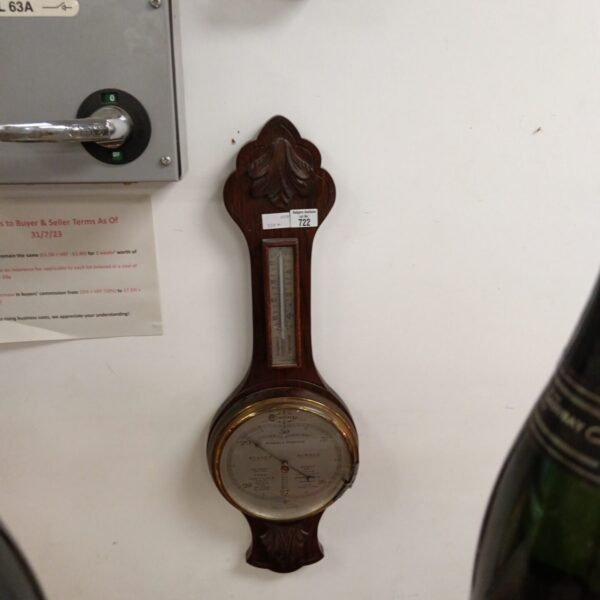 Vintage wooden cased barometer with circular dial.