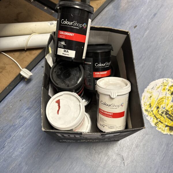 Assorted Rustoleum Colourshop paint cans in a cardboard box.