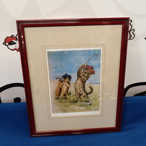 Vintage Louis Wain print of golfing cats in a frame.