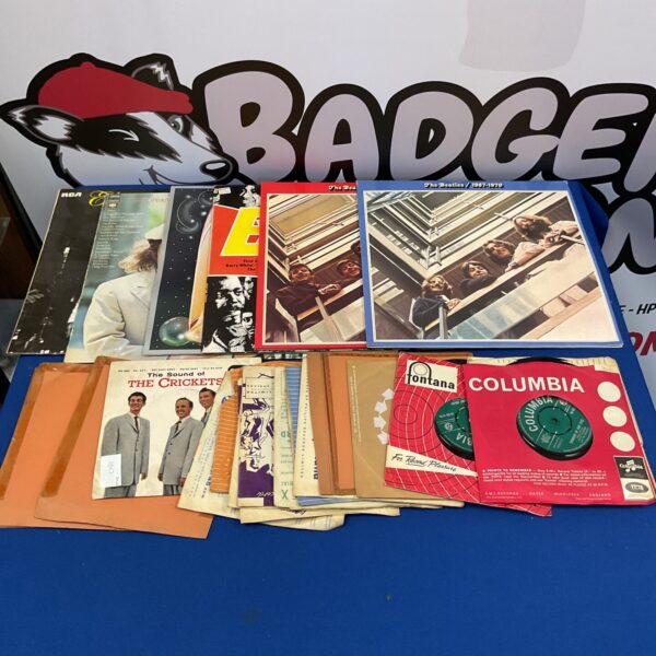 Vintage vinyl record collection featuring Beatles and Simon and Garfunkel records.