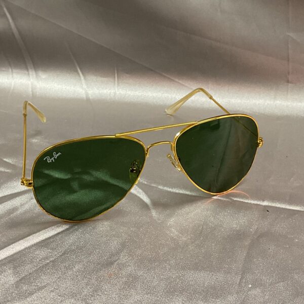Vintage Ray Ban aviator sunglasses with green lenses.