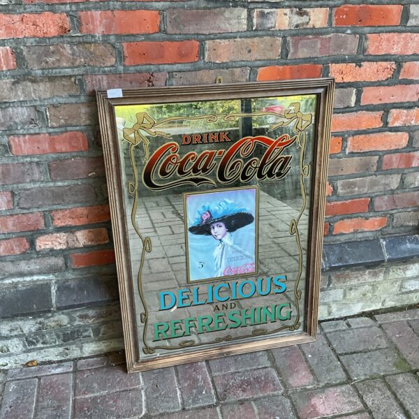 Large vintage Coca-Cola pub mirror with red logo.