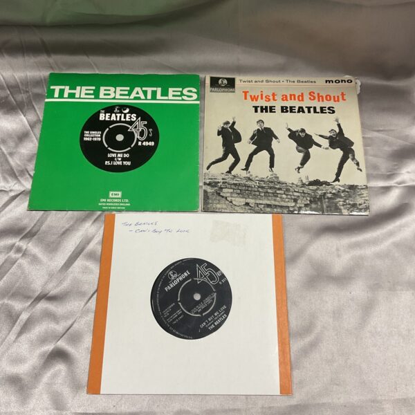 Beatles singles with original covers, vintage vinyl records.