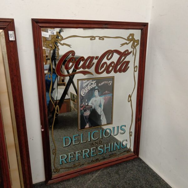 Vintage Coca Cola advertising mirror for pub decor.