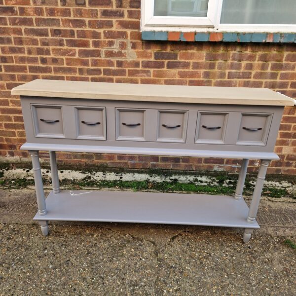 Painted hall console table with three drawers and turned legs.