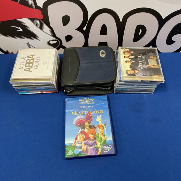 Collection of Disney DVDs and ABBA CDs for sale.