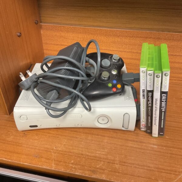 Microsoft Xbox 360 E console bundle with controller and cables.