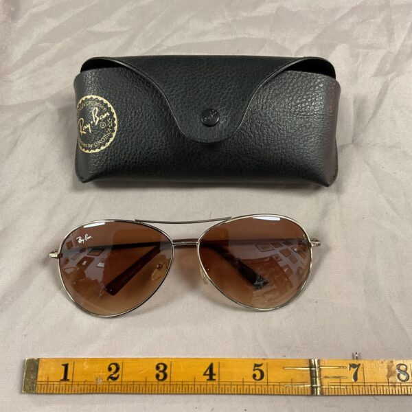 Gold-framed vintage Ray Ban sunglasses with teardrop lenses.