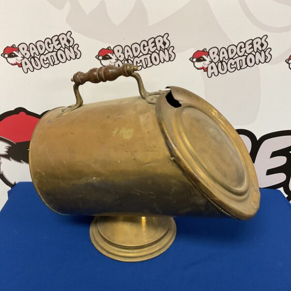 Antique Victorian brass coal bin with decorative handle.