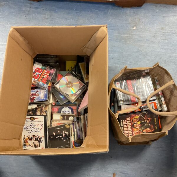 Large lot of CDs and DVDs for music and movie entertainment.