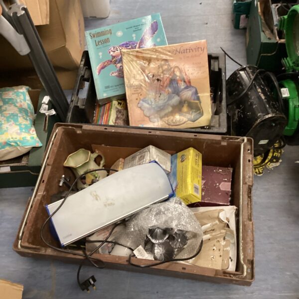 House clearance lot with mixed books and household items.