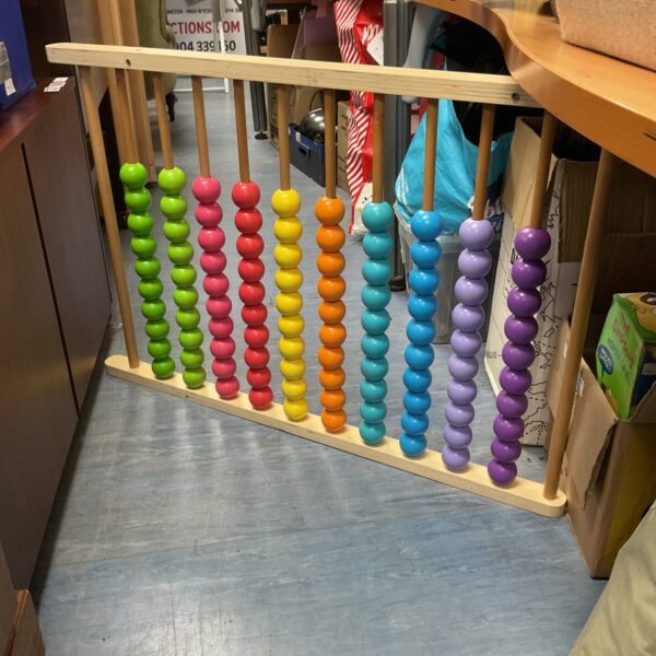 Colourful large wooden abacus with rainbow beads.