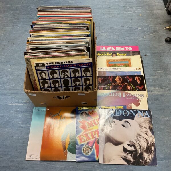 Large lot of vinyl records including Beatles and Madonna albums.