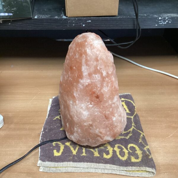 Functional Himalayan salt lamp with warm glow for home decor.
