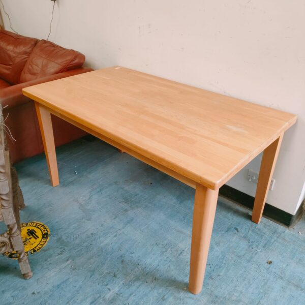 Solid oak dining table with visible wood grain and wear.