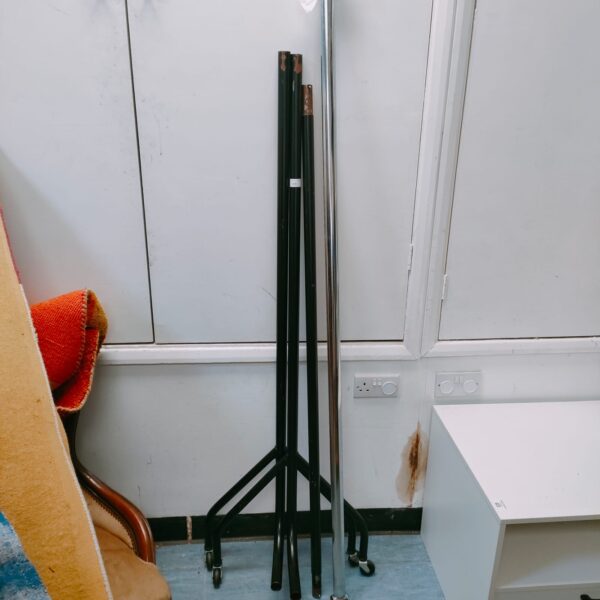 Freestanding metal clothes rail for garment storage.