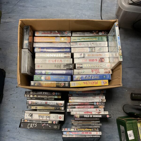 Assorted VHS and DVD movie collection, vintage home video entertainment.