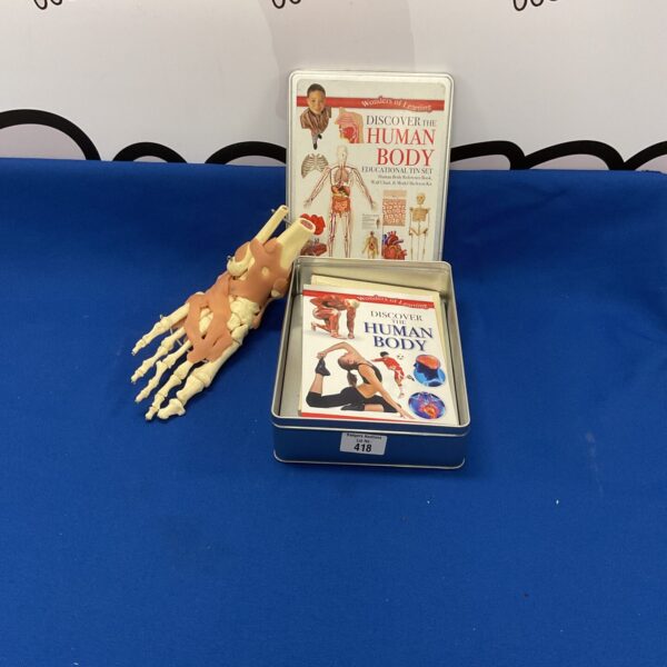 Vintage "Discover the Human Body" tin with anatomical foot model.
