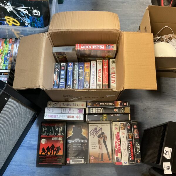 A box of vintage VHS movie cassettes, a retro film collection.