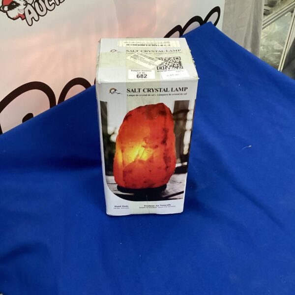 Himalayan salt crystal lamp with wooden base for home decor.