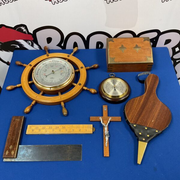 Antique ships wheel barometer with brass details and crucifix.