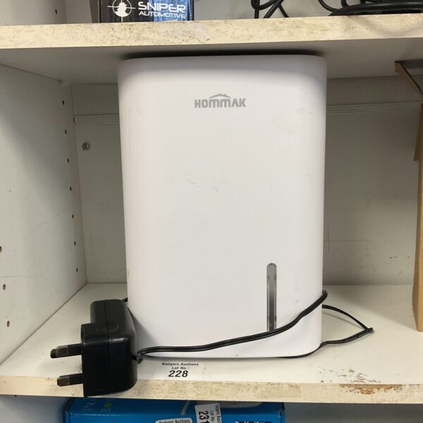 Small Hommak dehumidifier unit for moisture removal.