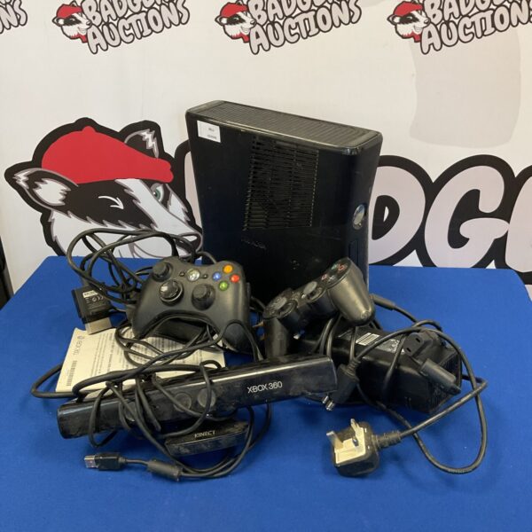 Microsoft Xbox 360 E console with controllers and cables for gaming.