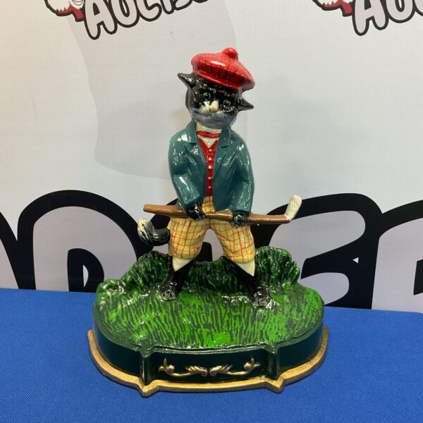 Vintage cast iron golfing cat doorstop, charming collectible figurine.