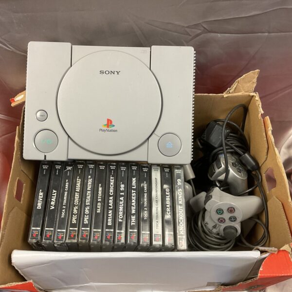 Vintage Sony PlayStation 1 console with thirteen included games.