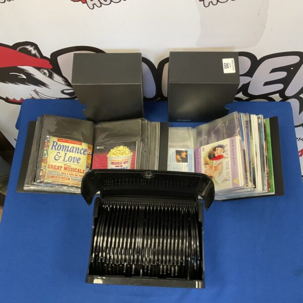 Stack of three cases filled with DVDs and music CDs.