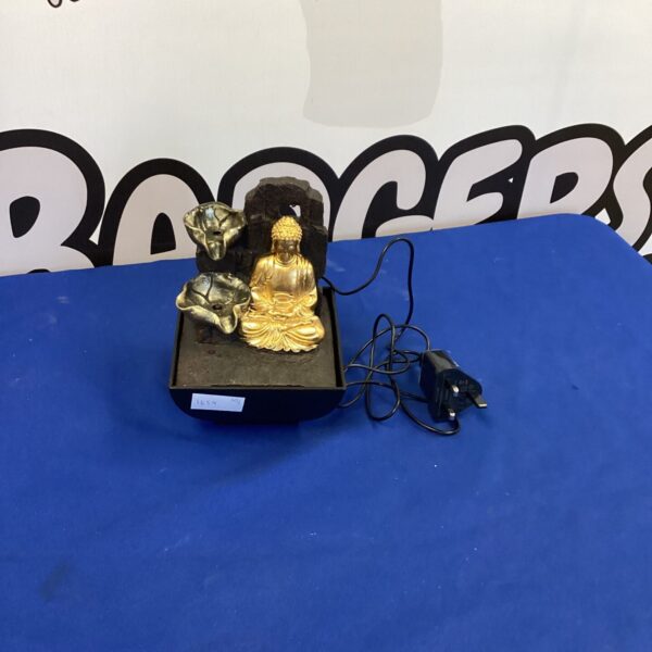 Small tabletop Buddha water feature for zen garden decor.