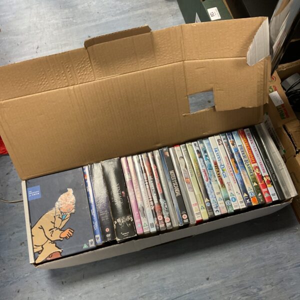 Tintin DVD box set and collection of DVDs in cardboard box.