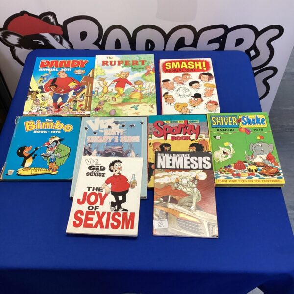 A stack of vintage annuals including Viz and The Dandy.