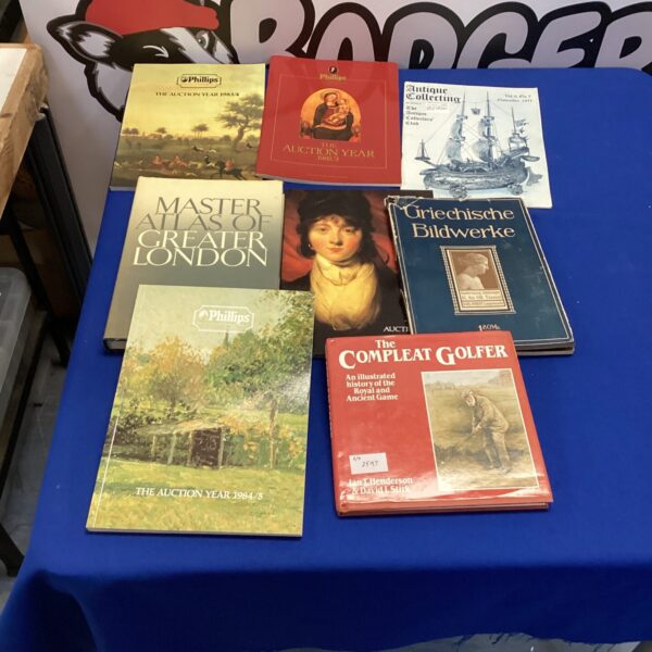 Vintage Phillips auction reference books, including London atlas and golfer's guide.