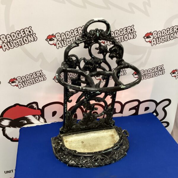 Ornate antique cast iron umbrella stand with Victorian detailing.