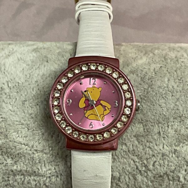 Pink Disney Winnie the Pooh child’s wristwatch with white strap.