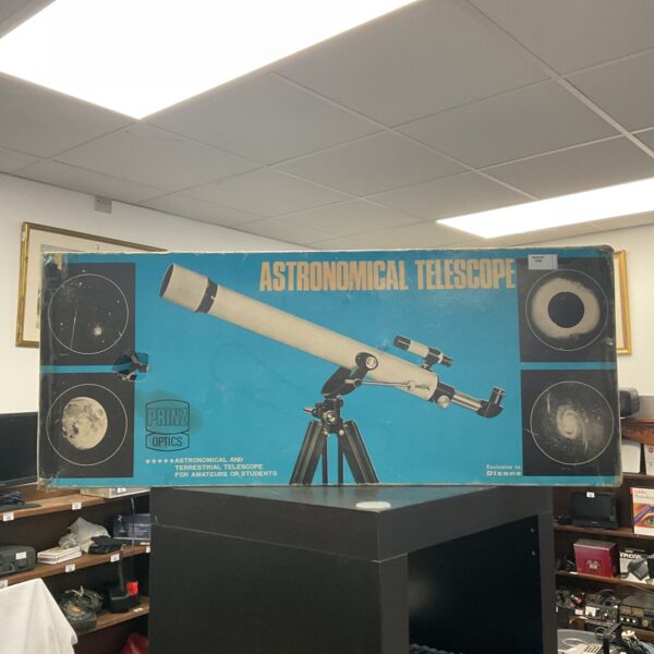 Vintage Prinz telescope on tripod for astronomical observation.