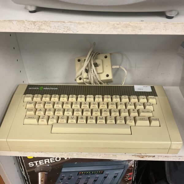 Vintage Acorn Electron computer with rubber keyboard and retro design.