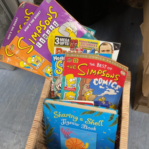 Mixed lot of children’s books and *The Simpsons* comics for collectors.