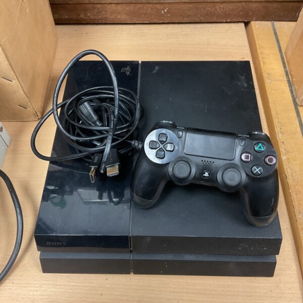 Black Sony PlayStation 4 console with a controller included.