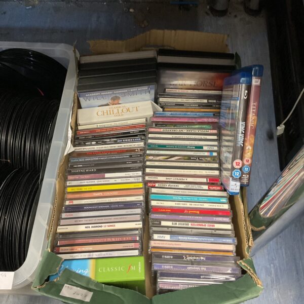 Mixed lot of music CDs, DVDs, and Blu-ray discs for collectors.