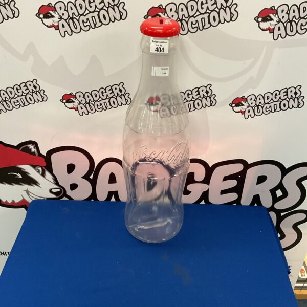 Large Coca-Cola money bottle, collectible promotional item.