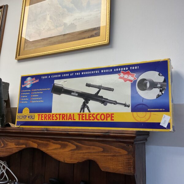 Vintage Discovery World terrestrial telescope for land observation.