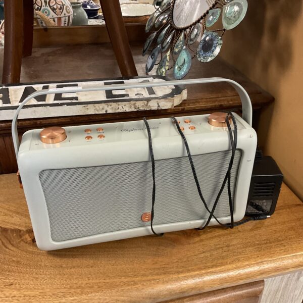 Front view of a Hepburn Voice DAB radio with power supply.