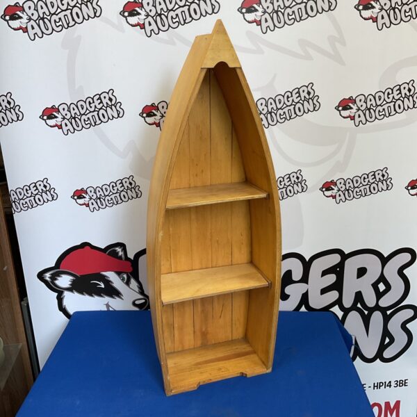 Wooden row boat bookshelf with three tiers for storage.