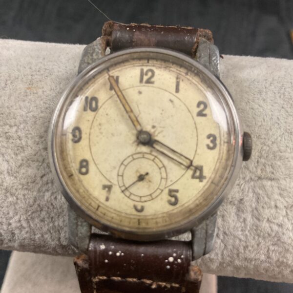 Vintage WW2 German military wristwatch with a weathered dial.